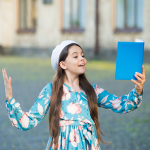Girl reciting poetry from a blue book
