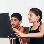 Girl and boy using a laptop computer