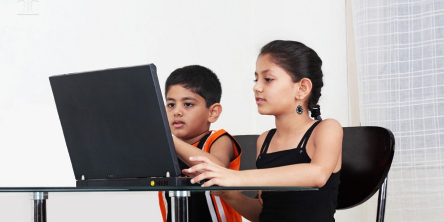 Girl and boy using a laptop computer